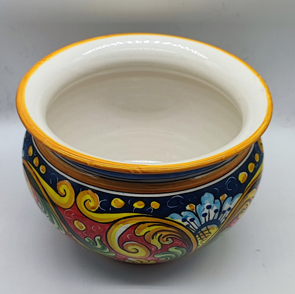 Traditional Sicilian ceramic cachepot displayed in an elegant living room as a colorful Mediterranean home decor accent.