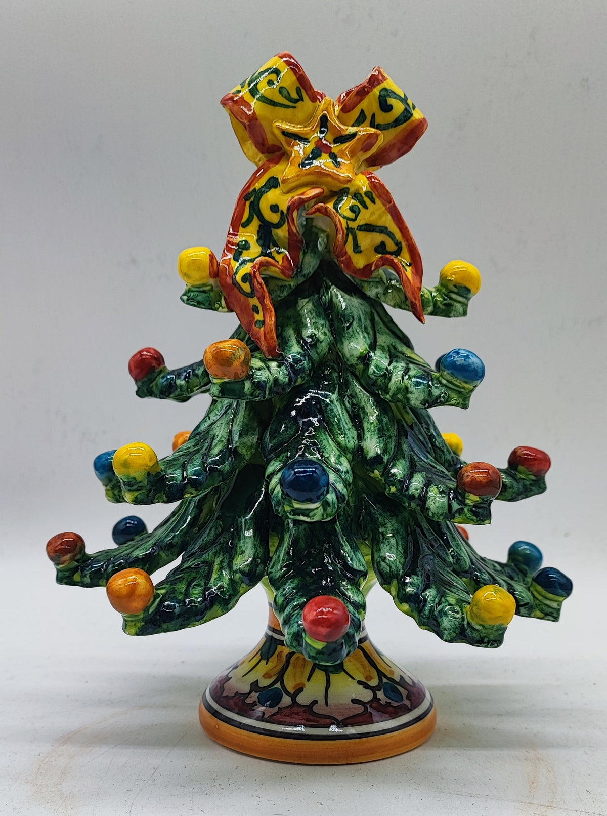 Hand-painted Italian ceramic Christmas tree presented as a unique holiday gift