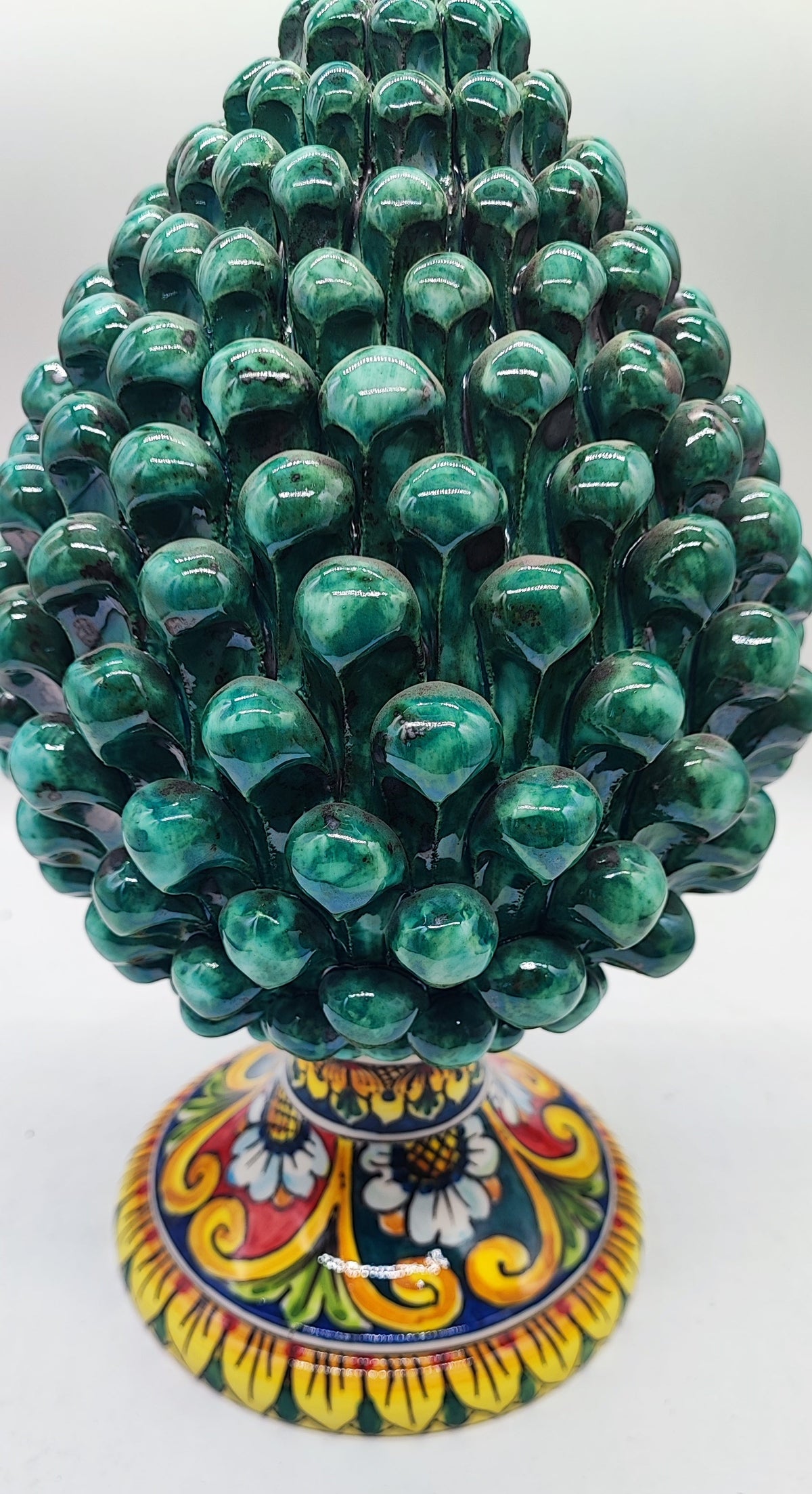 Handmade green Sicilian ceramic pine cone, a traditional Italian good luck symbol and elegant housewarming gift.