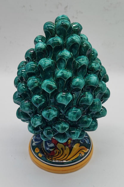 Green Sicilian ceramic pine cone displayed in an elegant rustic country-style living room