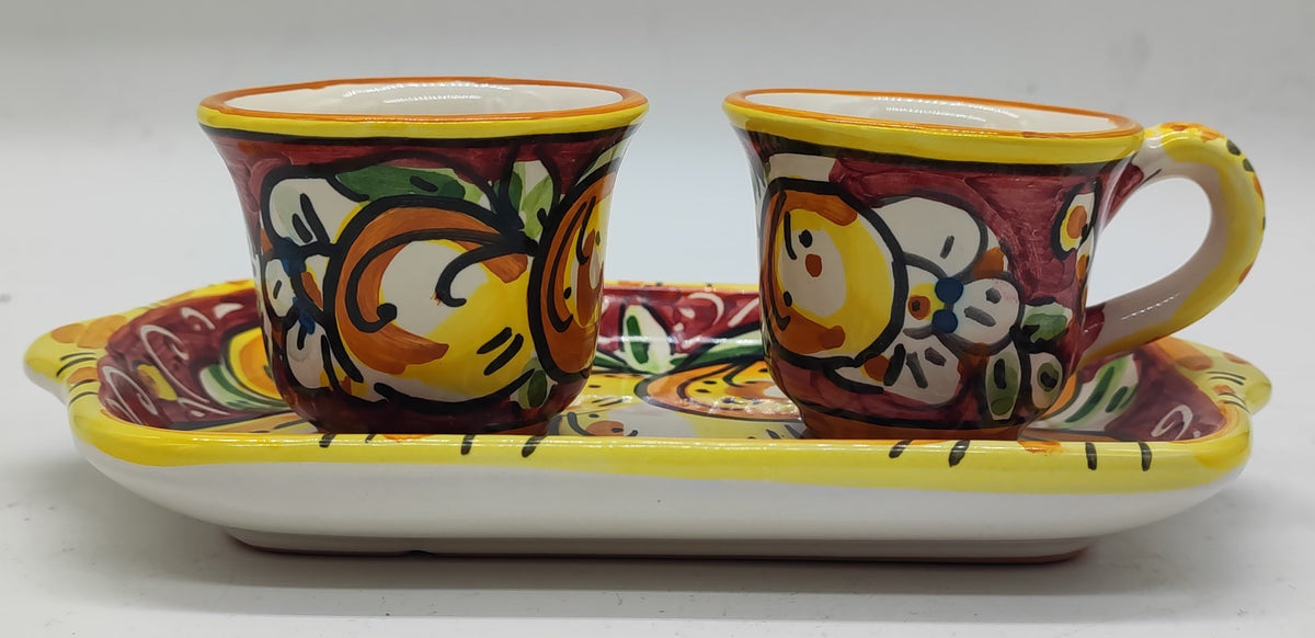 Italian ceramic espresso set displayed beside a coffee machine in a Mediterranean style kitchen