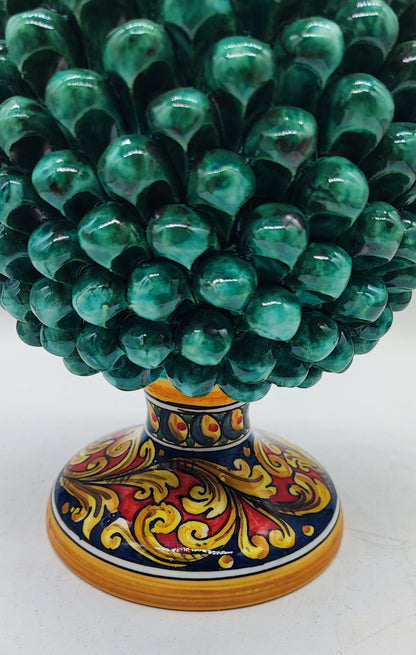 Close-up of the traditional Sicilian majolica pedestal decorated with hand-painted yellow, red, green and blue floral patterns.