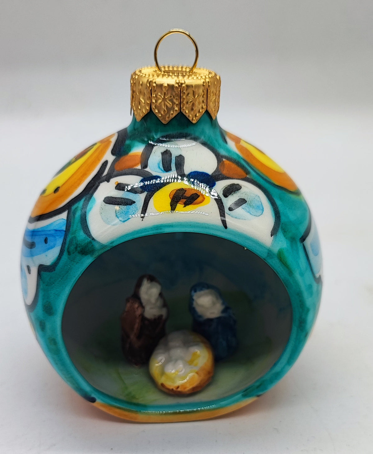 Turquoise Sicilian ceramic Christmas bauble with miniature Nativity scene