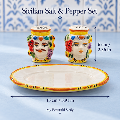 Colourful Moorish head salt and pepper set on a walnut table in an olive-green kitchen
