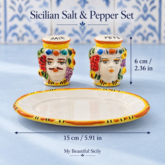 Colourful Moorish head salt and pepper set on a walnut table in an olive-green kitchen