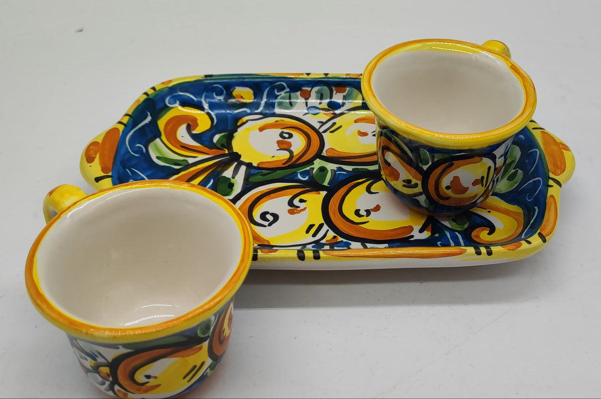 Close up of colorful hand painted majolica decoration on Sicilian ceramic coffee set
