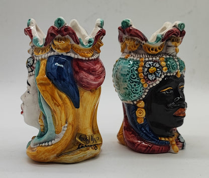 Side view of the ceramic Moorish heads showing the sculpted shape and painted decoration.