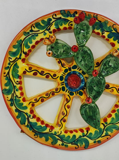 Yellow hand-painted Sicilian ceramic cart wheel with green prickly pear cactus and colourful fruit, 16 cm in diameter.