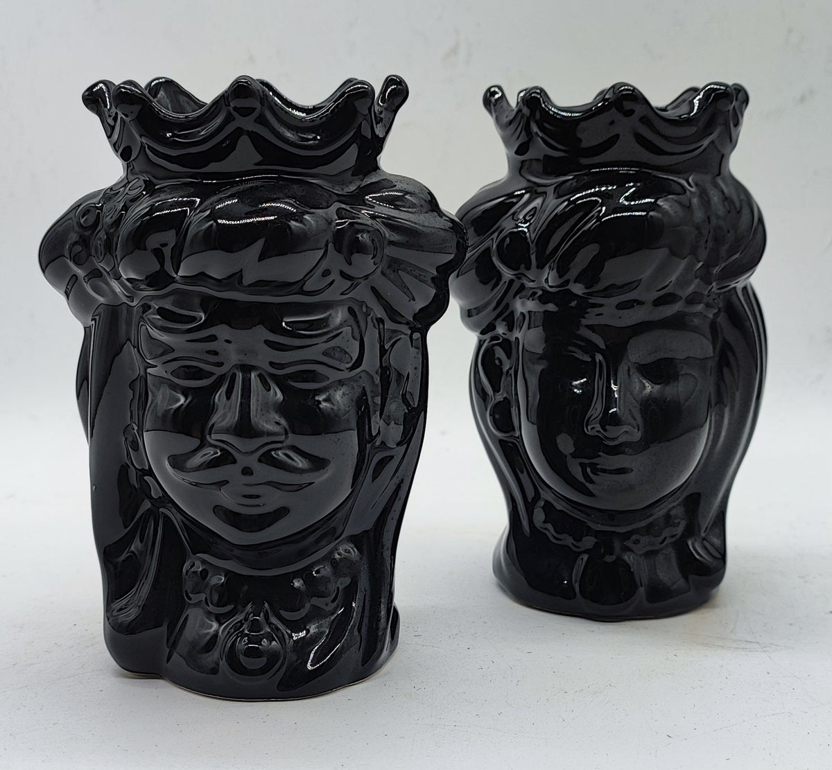 T: Front view of a glossy black Sicilian ceramic Moorish Head couple featuring a crowned man and woman, handmade in Italy.