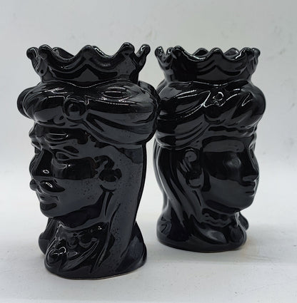 Side profile of two handmade black Sicilian Moorish Head ceramics showing sculpted crowns, facial details and glossy glaze.
