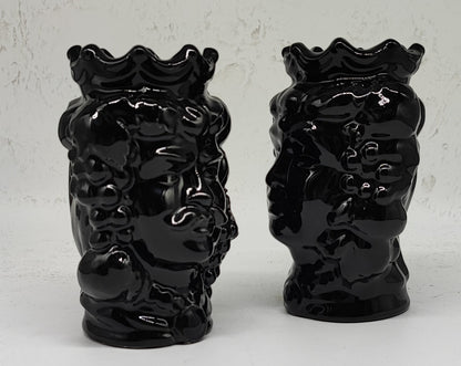 Close-up of the sculpted face and glossy black glaze on a Sicilian Moorish head vase