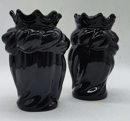 Back view of a pair of glossy black handmade Sicilian ceramic Moorish Heads with detailed crowns and hair.