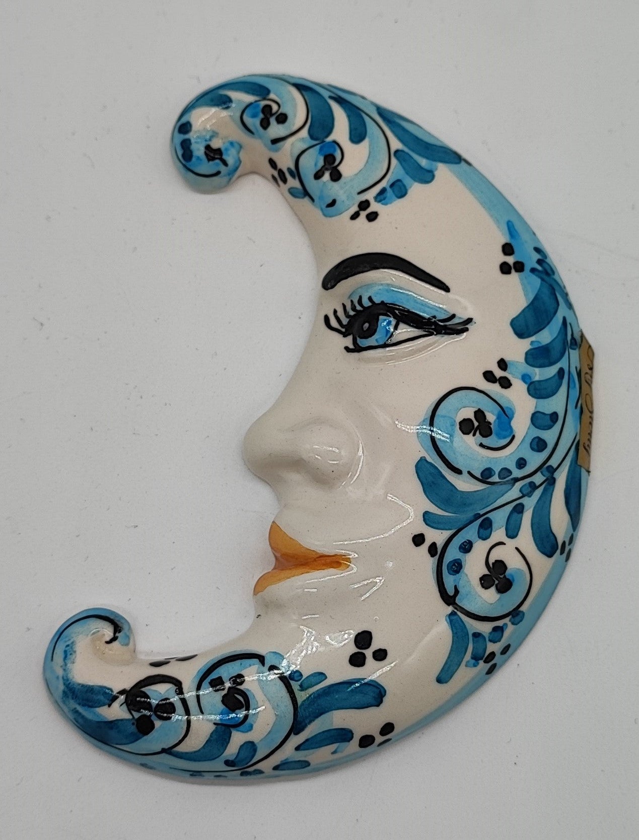 Handmade blue and white Sicilian ceramic crescent moon with sculpted face and painted scrollwork