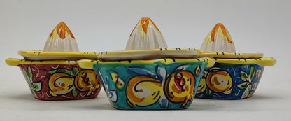 Colorful Caltagirone-style ceramic citrus juicers displayed in a Mediterranean kitchen