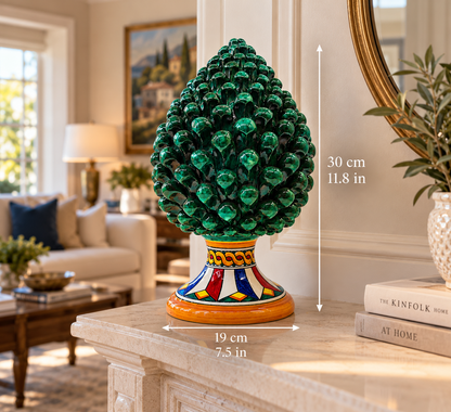Traditional Sicilian ceramic Pigna with a deep emerald green glossy finish and a colorful hand-painted geometric base.