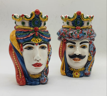 Front view of colorful Sicilian Teste di Moro ceramic heads with decorative crowns, female and male matching set.