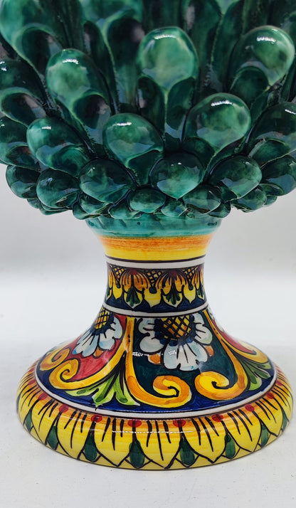 Close-up of the colorful hand-painted Sicilian majolica pedestal featuring yellow, blue, green and red floral patterns.