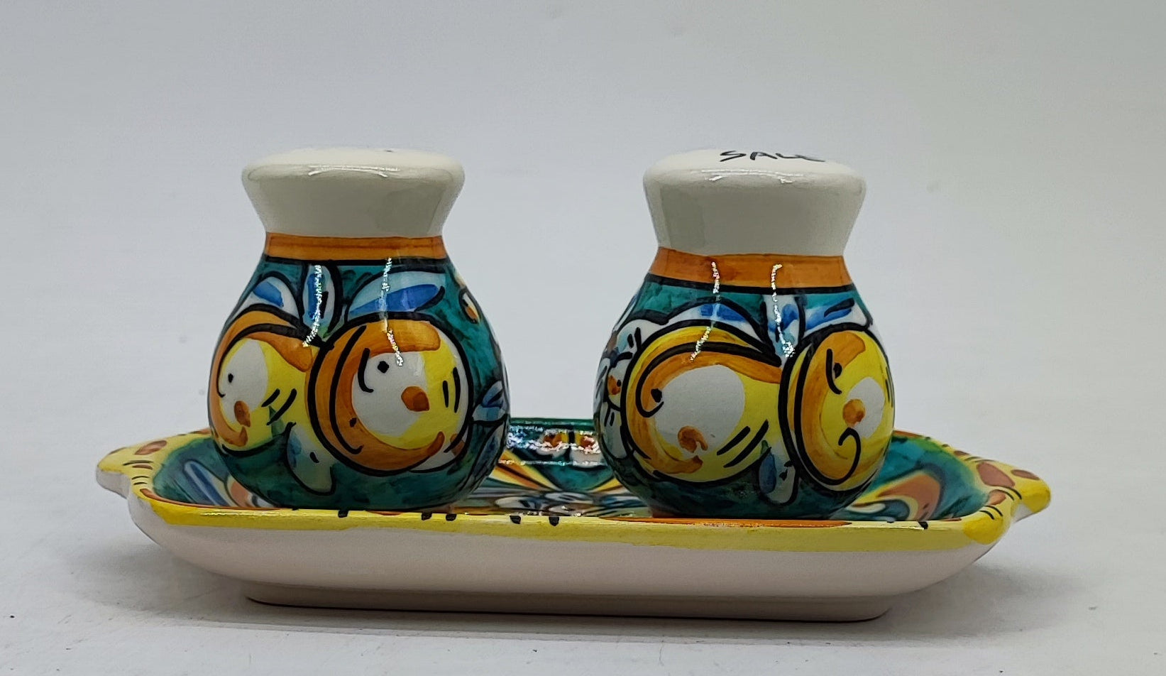 Hand-painted Caltagirone-style salt and pepper set displayed in a Mediterranean kitchen