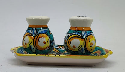 Hand-painted Caltagirone-style salt and pepper set displayed in a Mediterranean kitchen