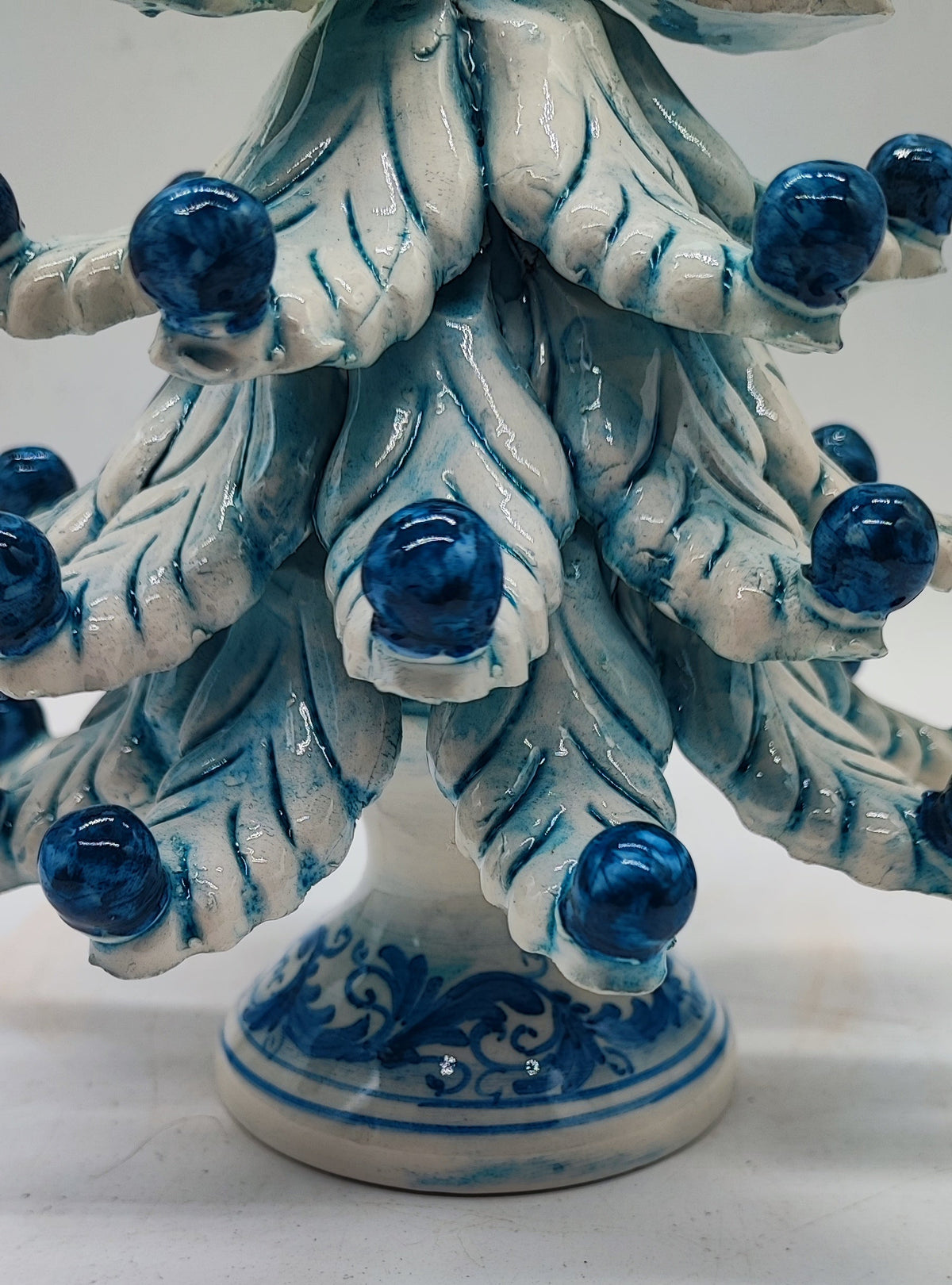 Blue and white Caltagirone ceramic Christmas tree measuring 21 cm high and 17 cm wide, approximately 8.3 by 6.7 inches.