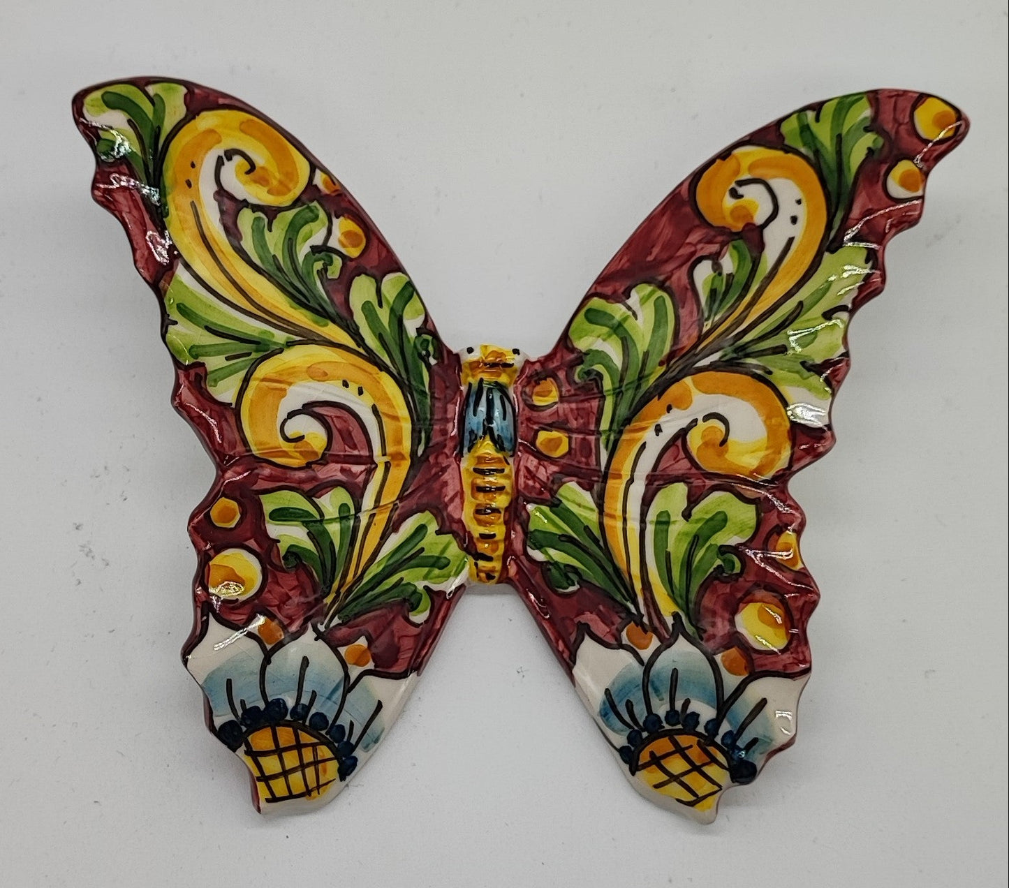 Hand-painted Sicilian ceramic butterflies arranged as colorful wall decor