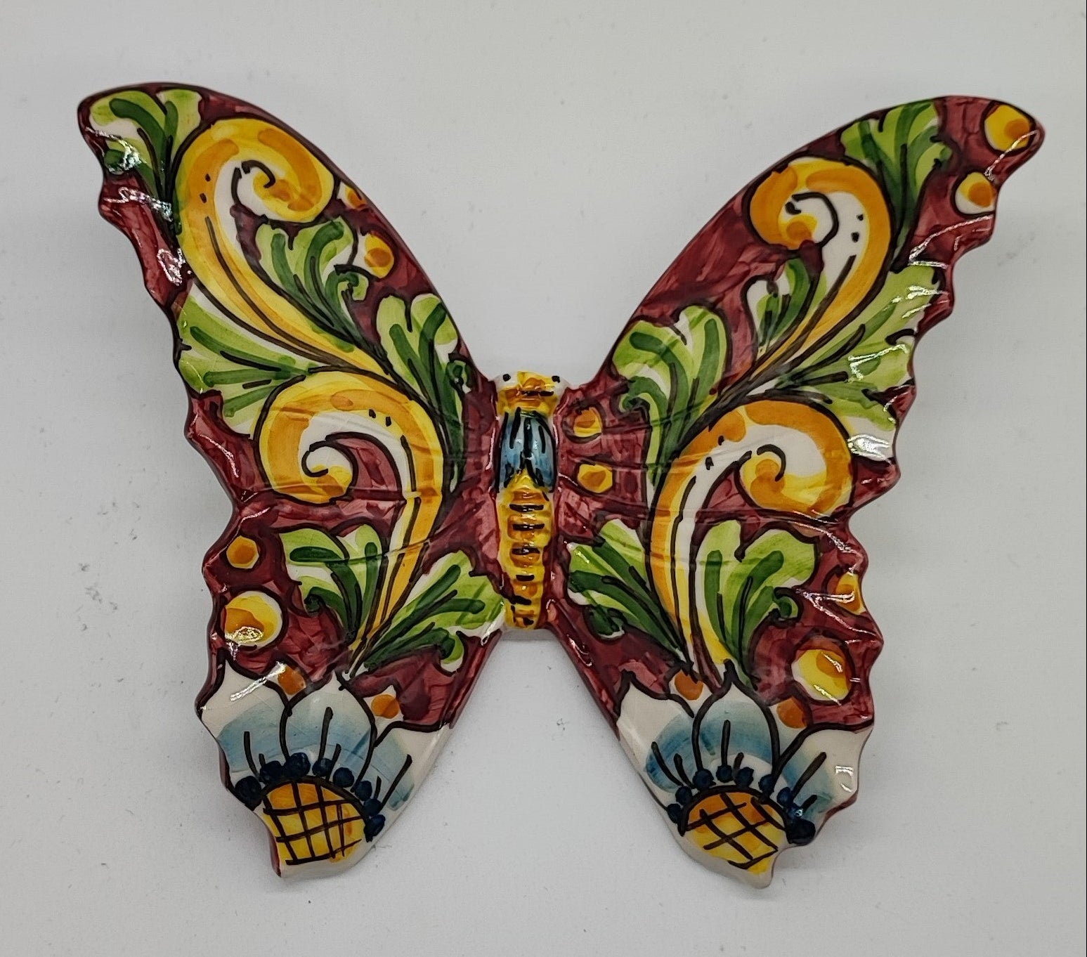 Hand-painted Sicilian ceramic butterflies arranged as colorful wall decor