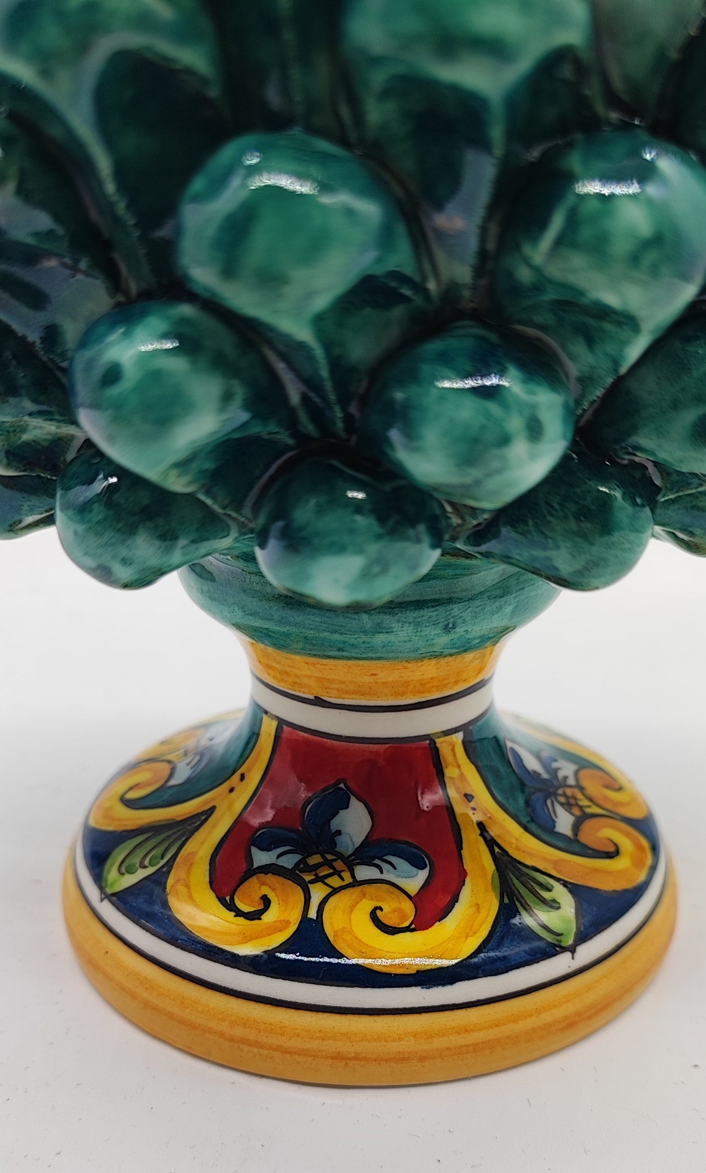 Emerald green Sicilian ceramic pine cone displayed on a romantic fireplace mantel, height 21 cm