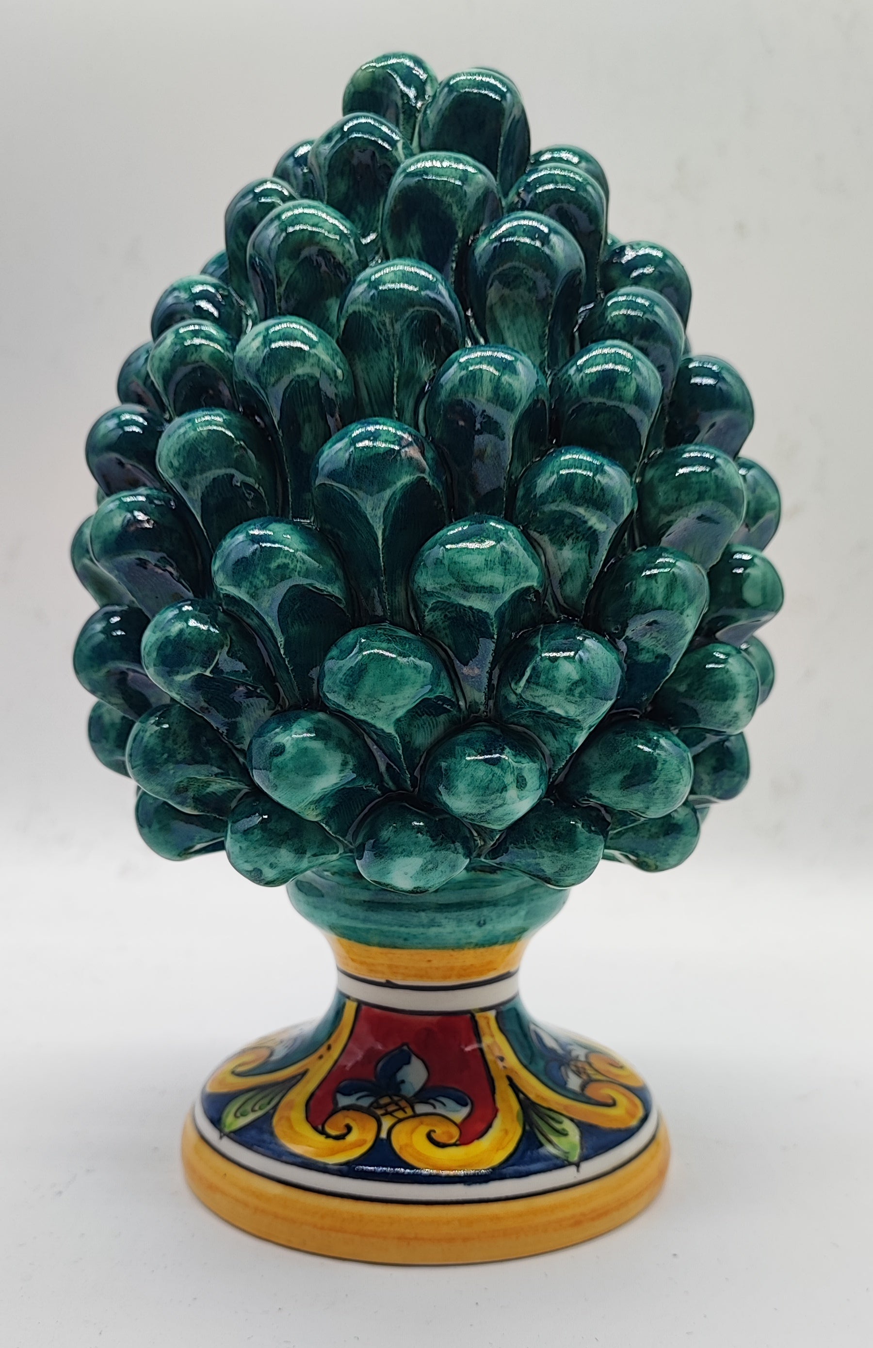 Emerald green Sicilian ceramic pine cone displayed on a romantic fireplace mantel, height 21 cm