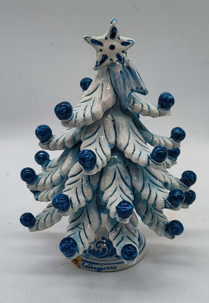 Close-up of hand-painted cobalt blue ornaments and traditional Sicilian decorative details on a ceramic Christmas tree.