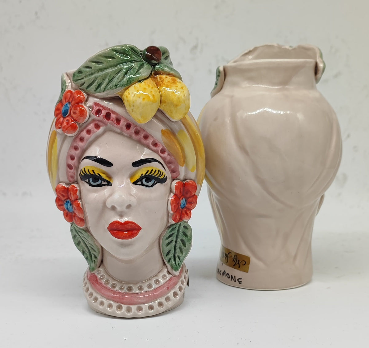 Close-up of hand-painted Sicilian Moorish Heads with yellow lemons, green leaves and traditional ceramic details