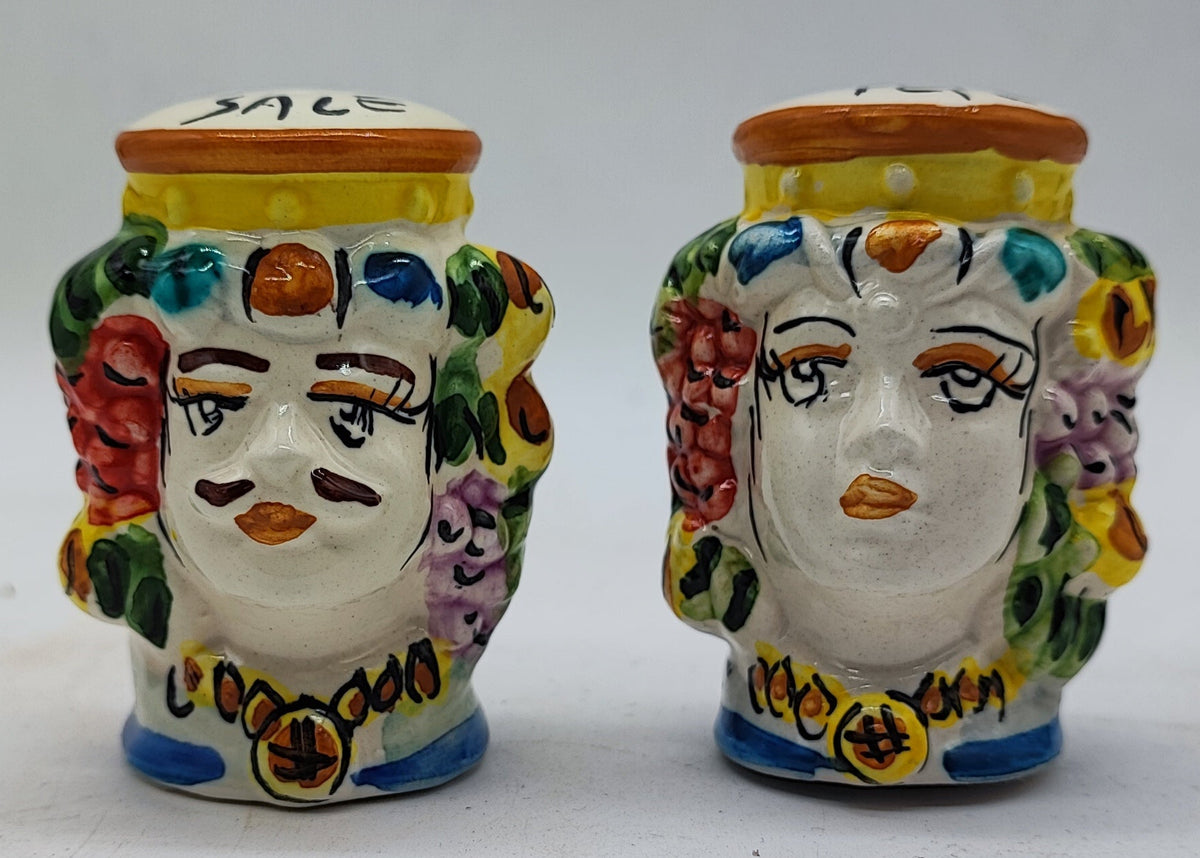 Front view of two hand-painted Sicilian ceramic salt and pepper shakers with colorful floral decorations.