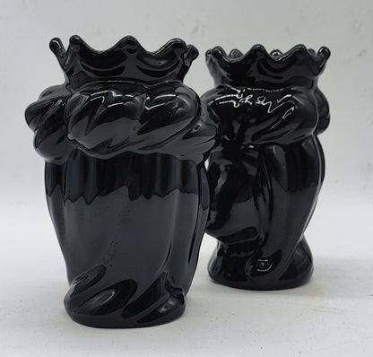 Angled view of glossy black Italian ceramic Moorish Heads with traditional sculpted details and decorative crowns.