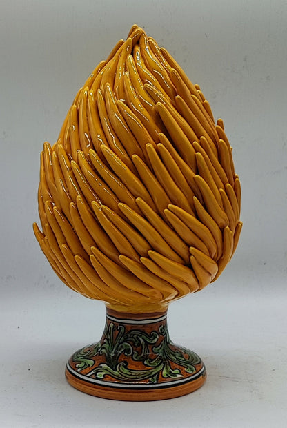 Close-up of handcrafted yellow Sicilian ceramic pine cone details