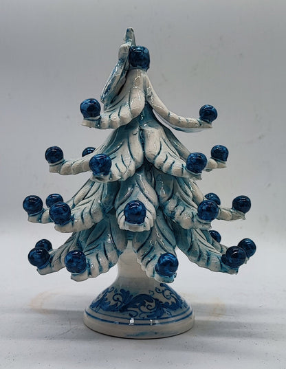 Elegant blue and white ceramic Christmas tree displayed in a living room as Italian holiday home decor.