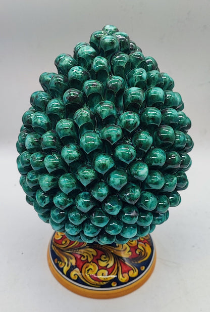 Traditional green Caltagirone ceramic pine cone styled on an elegant console in a classic American living room.