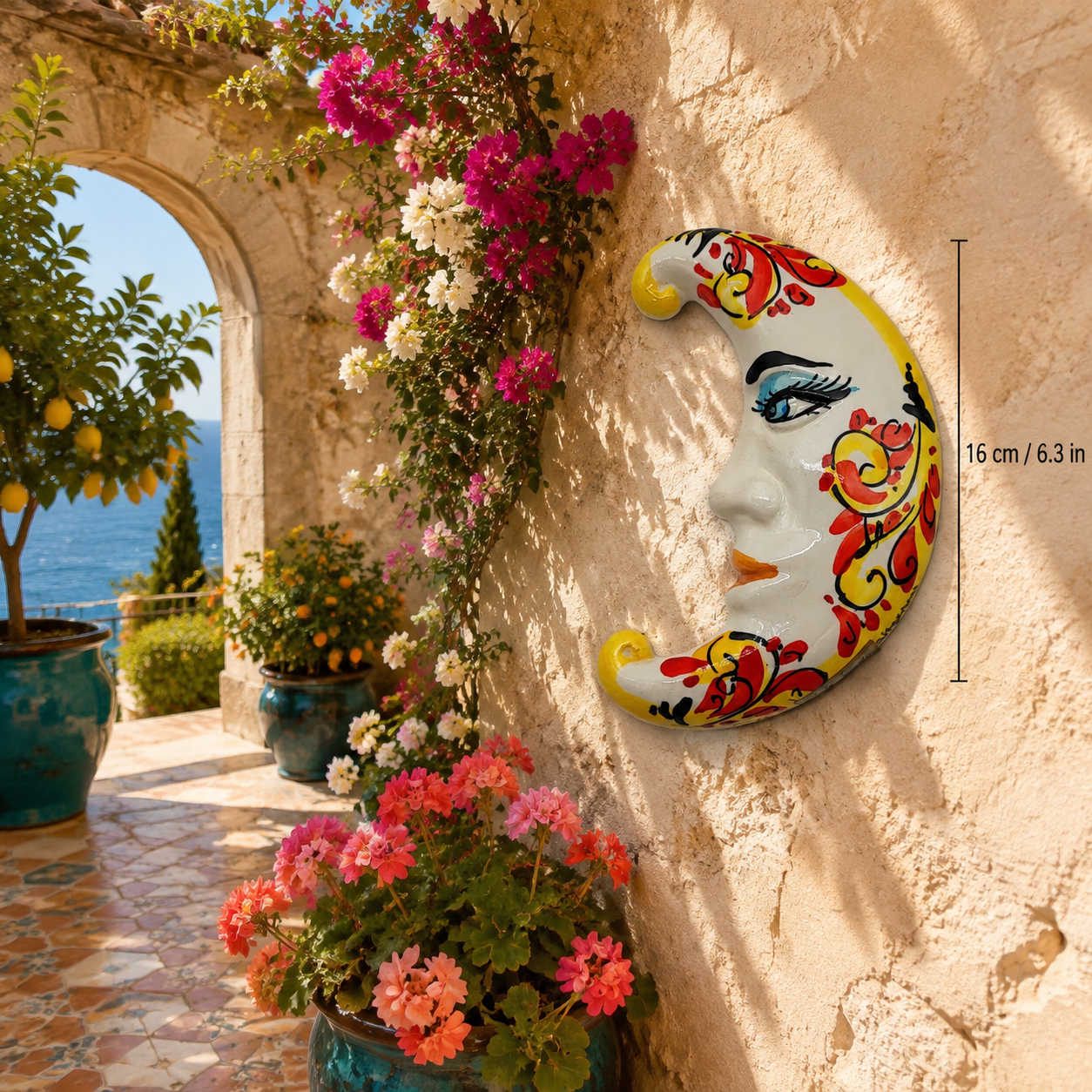 Handmade Sicilian ceramic crescent moon with red and yellow hand-painted scroll decoration