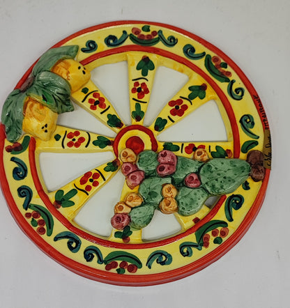 Yellow Sicilian ceramic cart wheel with raised lemons, green leaves and prickly pears, 21 cm in diameter.