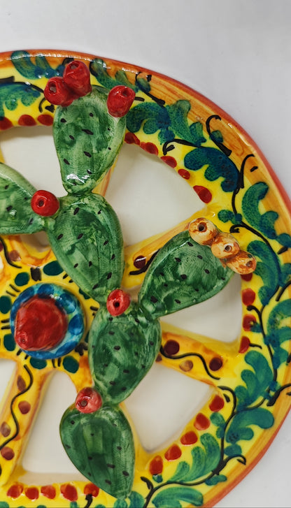 Yellow hand-painted Sicilian ceramic cart wheel with green prickly pear cactus and colourful fruit, 16 cm in diameter.