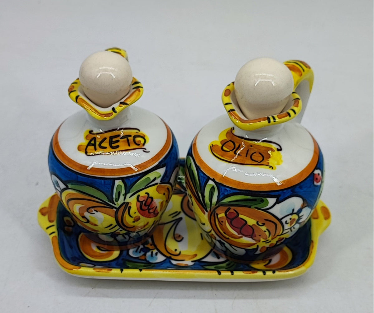 Sicilian ceramic oil and vinegar bottles measuring 14 cm high with a 20 cm serving tray