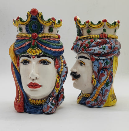 Female Sicilian Moorish Head facing forward beside male ceramic head in profile, showing traditional hand-painted decorations.