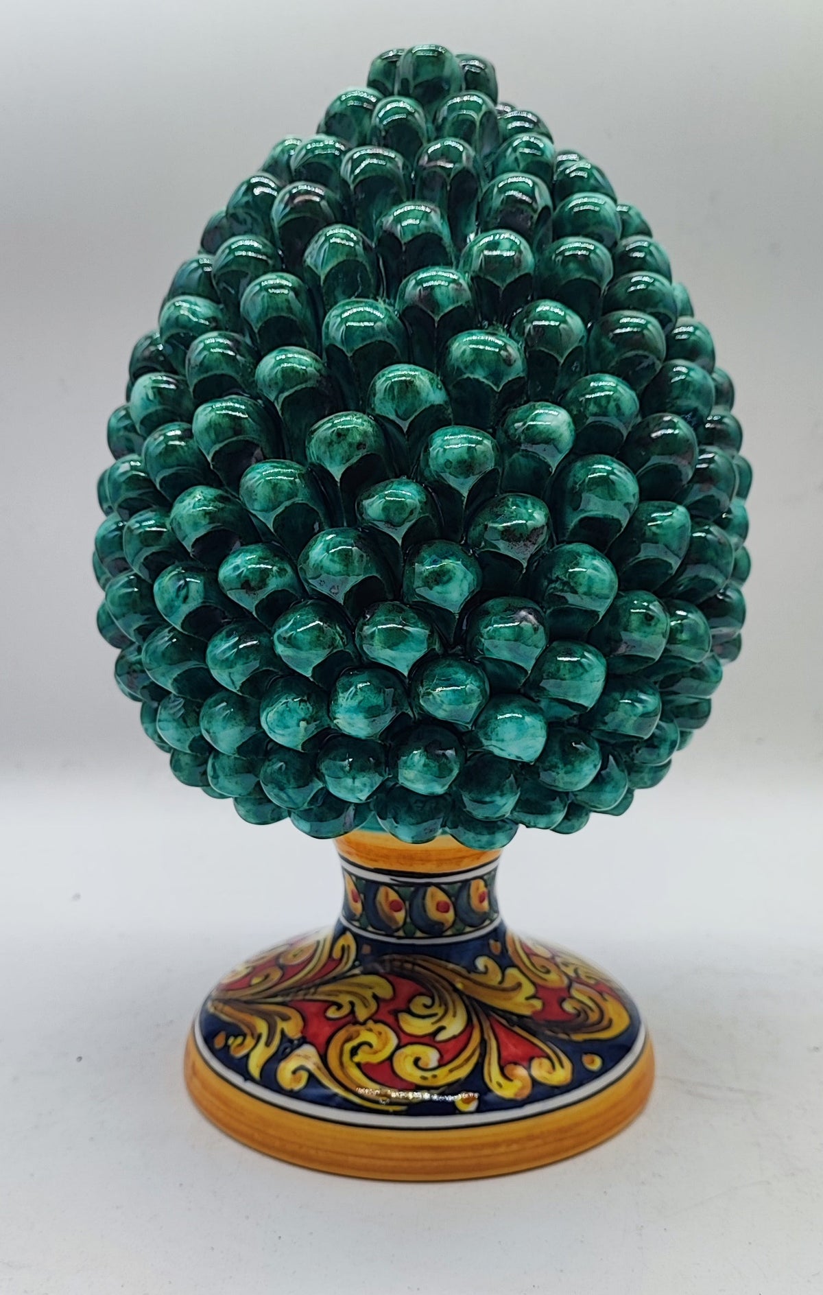 Sicilian ceramic pine cone measuring 27 cm (10.6 inches) tall and 16 cm (6.3 inches) wide on a marble fireplace mantel.