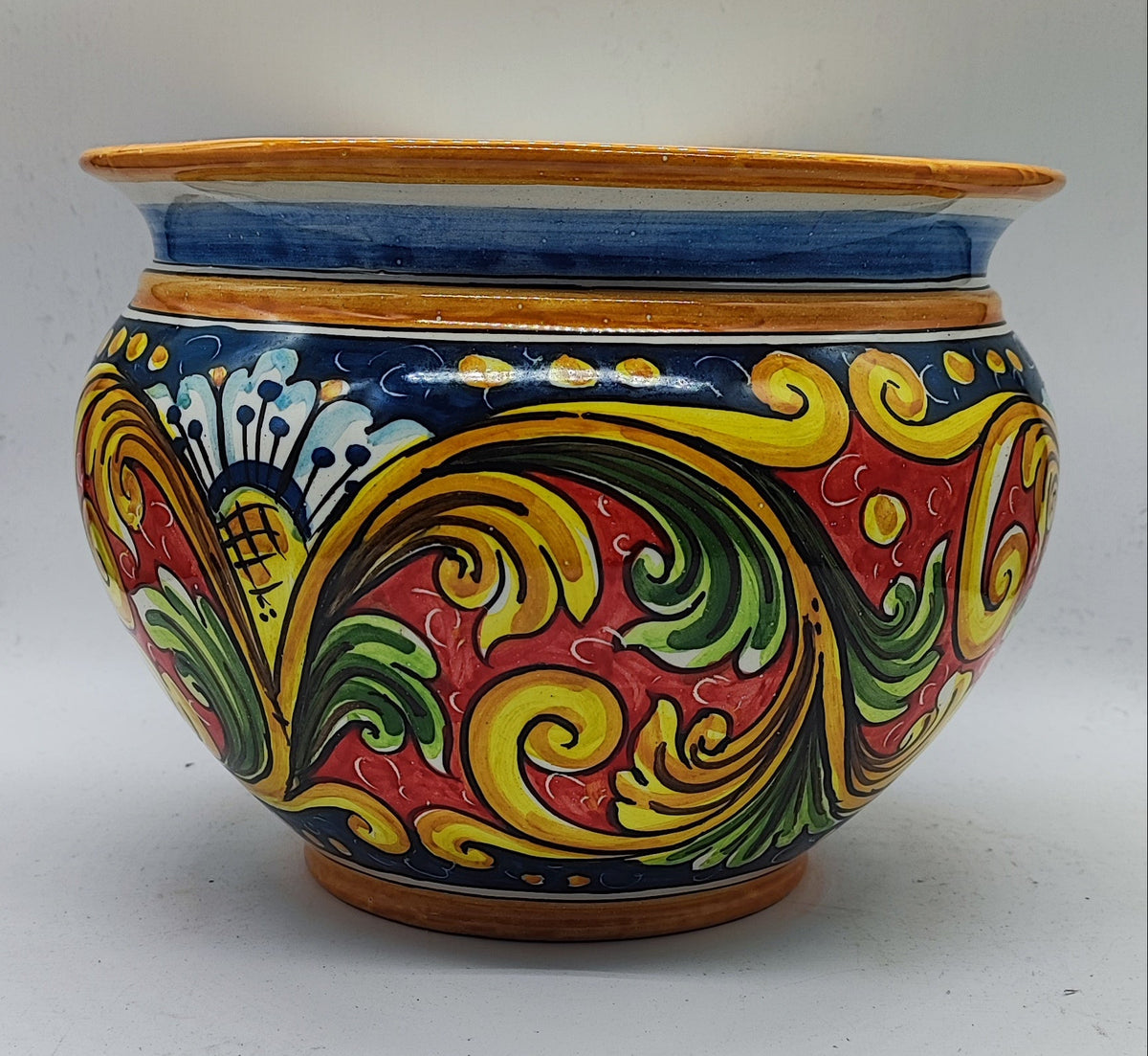 Close-up of colorful hand-painted Caltagirone majolica floral patterns in cobalt blue, yellow, red and green.