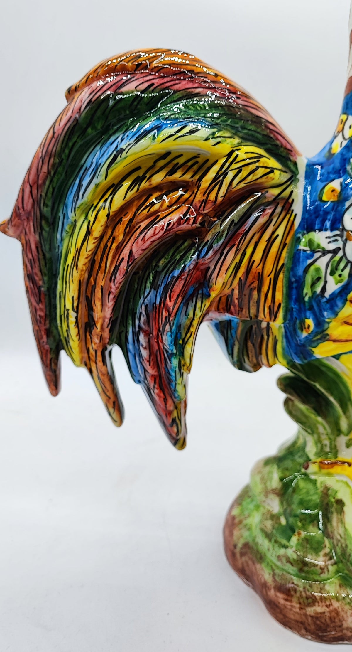 	Multicolored glazed ceramic rooster tail with intricate artisan painting