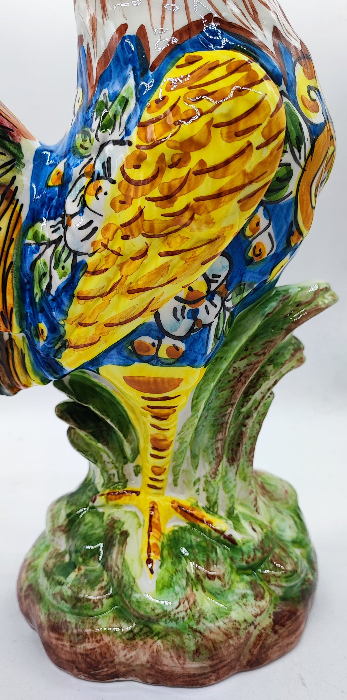 	Yellow hand painted ceramic rooster wing with blue floral majolica decoration