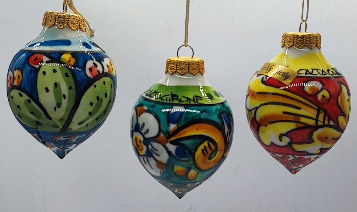 Three authentic Sicilian ceramic Christmas baubles in blue, turquoise and yellow, featuring traditional hand-painted majolica designs.