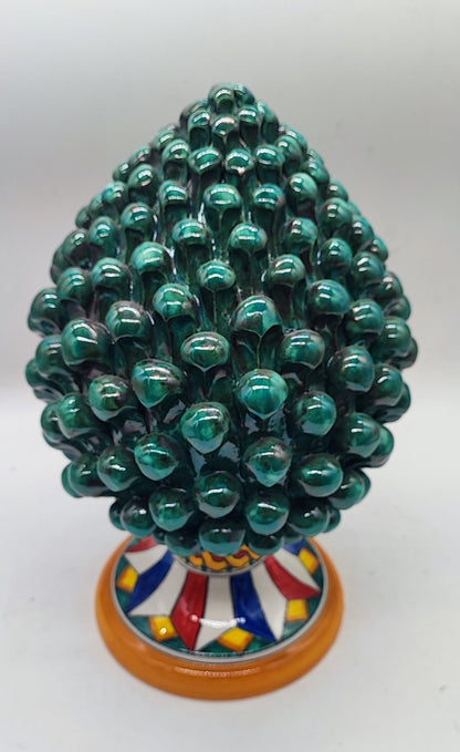 Close-up of the hand-painted Caltagirone ceramic pedestal featuring traditional red, blue, yellow and green geometric patterns