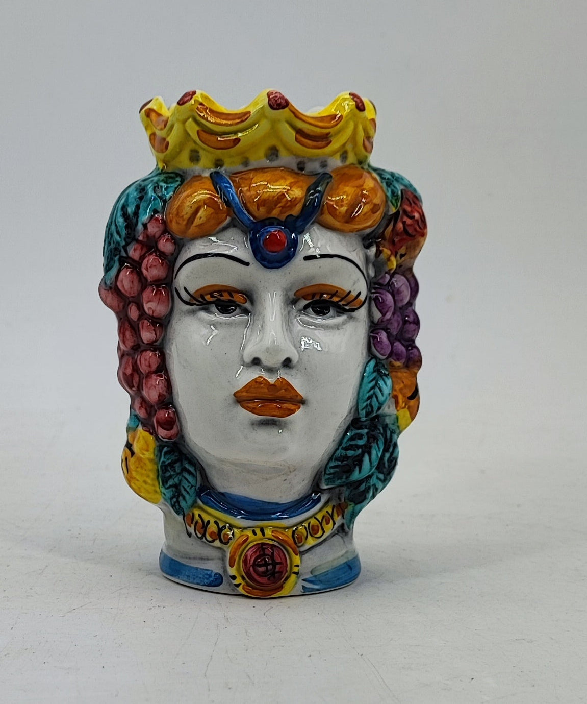 Close-up of colorful fruit and hand-painted details on a small Sicilian Moor’s Head