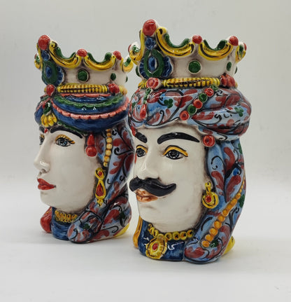 Male Sicilian Moorish Head facing forward with female ceramic head in side profile, decorated in traditional majolica colors.