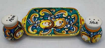 Front view of a turquoise-green Sicilian ceramic salt and pepper set with fruit decoration