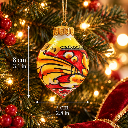 Yellow and red Sicilian ceramic Christmas ornament hanging on a tree, showing 8 cm height and 7 cm width.